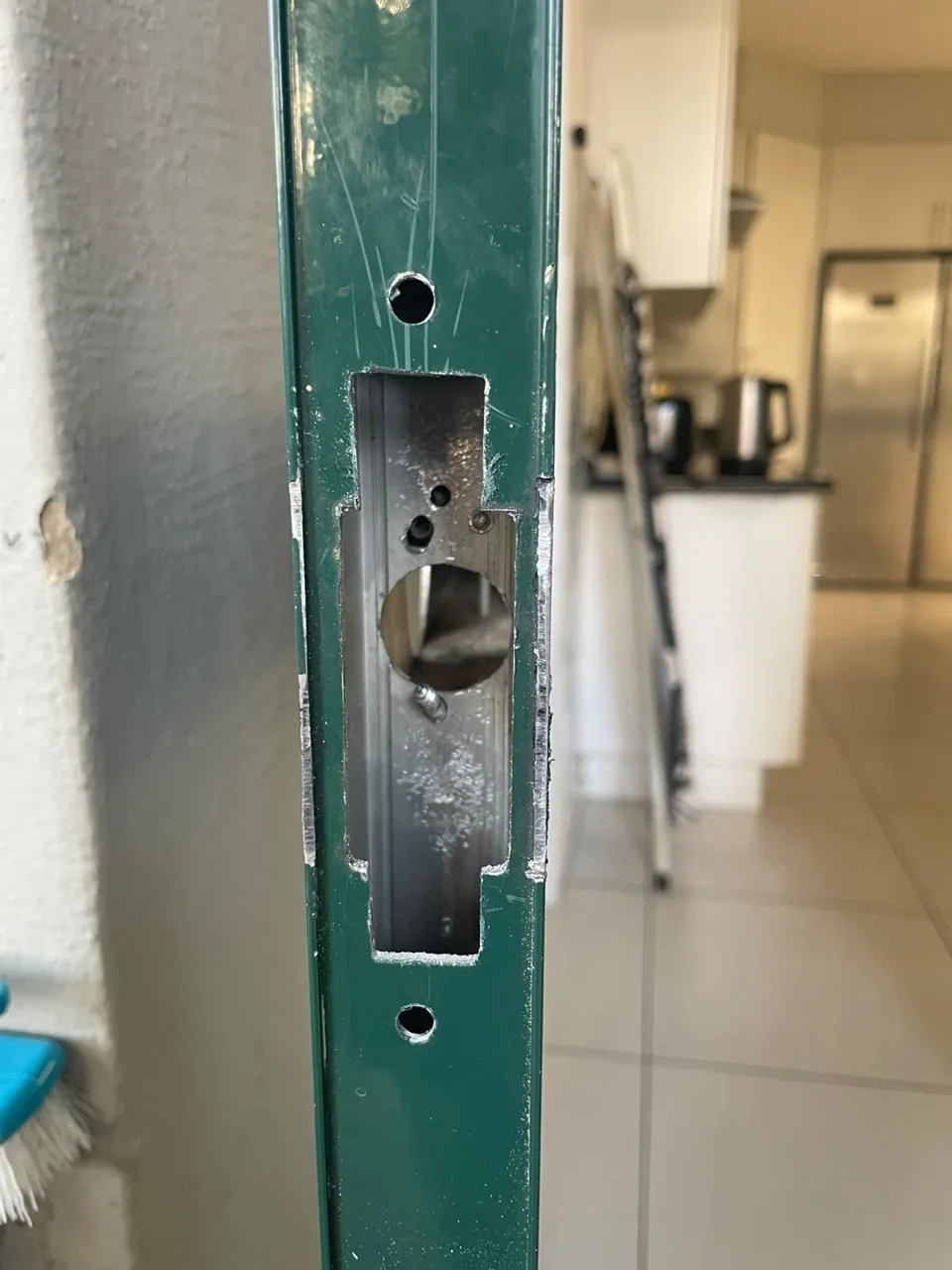 Green security gate with the lock recess exposed